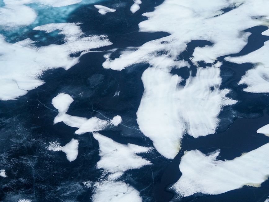 Aerial view of striking ice patterns on a frozen lake in Norilsk, Russia. Captivating and abstract.