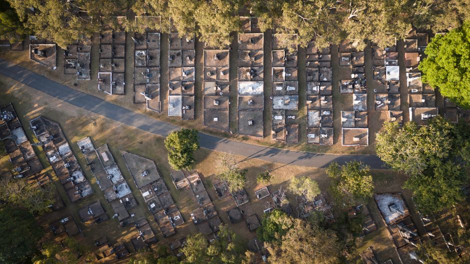 Drone view of Toowong Cemetery, Brisbane, showcasing graveyard layout and natural surrounds.