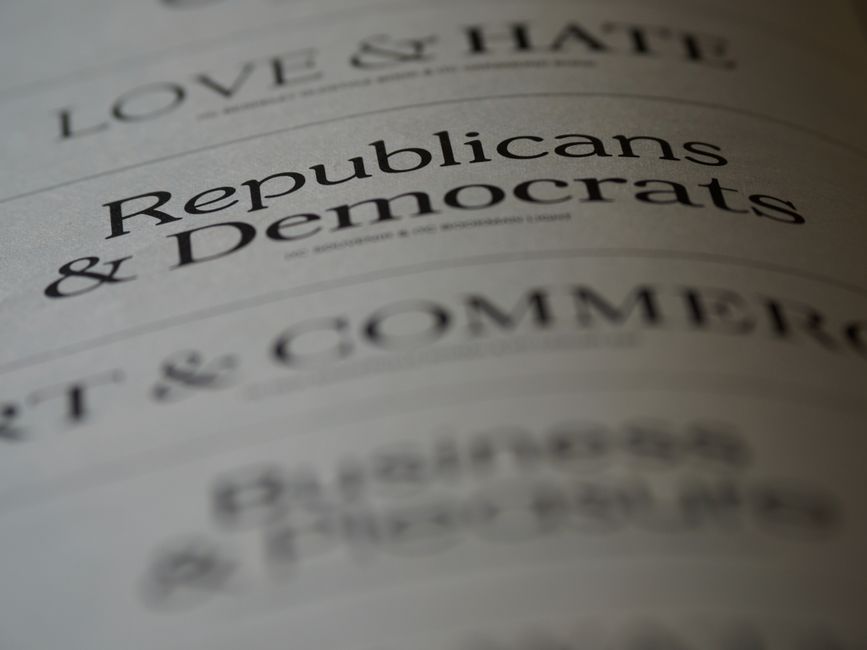 Close-up of blurred text page with 'Republicans & Democrats', focusing on political themes.