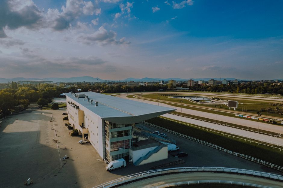 Aerial shot of Kincsem Park horse racing track in Budapest, Hungary during a sunny day.