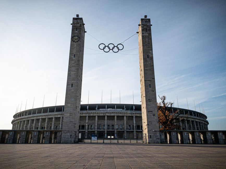 View of the Olympic Stadium in Berlin featuring the Olympic rings between two towers.