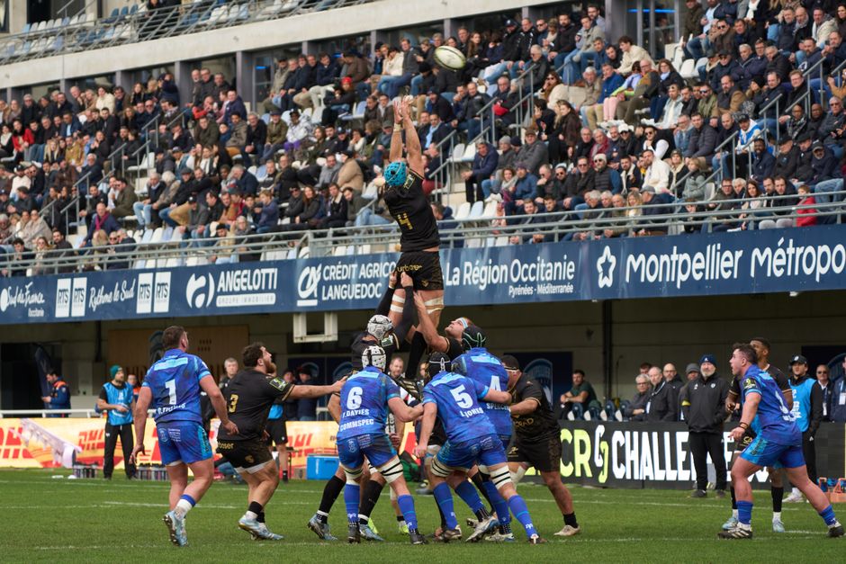 Exciting rugby match with crowds cheering at a stadium in Montpellier, Occitanie, France.
